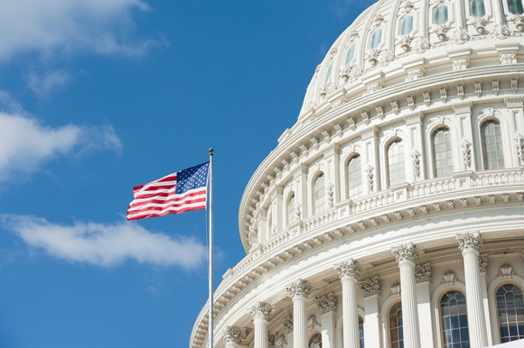 An American flag flying outside the Capitol dome.