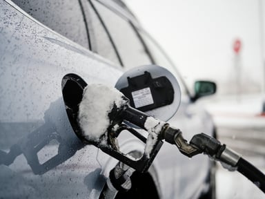 Gas pump nozzle inserted into a car