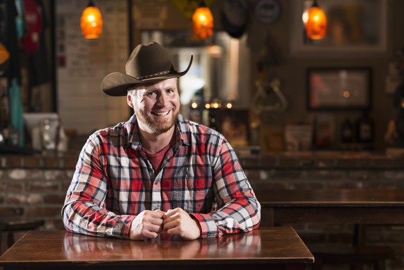 Person at bar with cowboy hat.