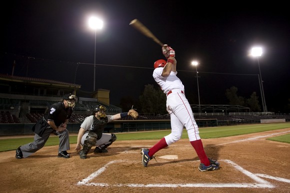 Baseball batter swings at pitch. 
