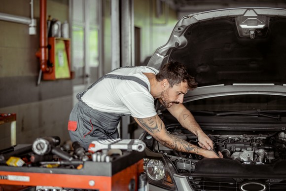 A mechanic working on a vehicle.