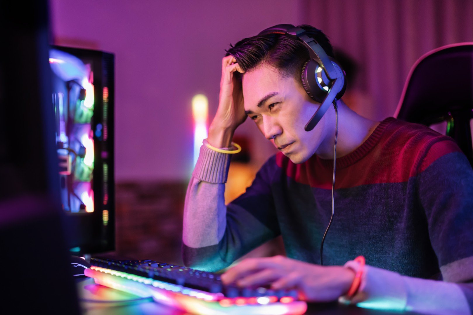 A person with headset using a keyboard.