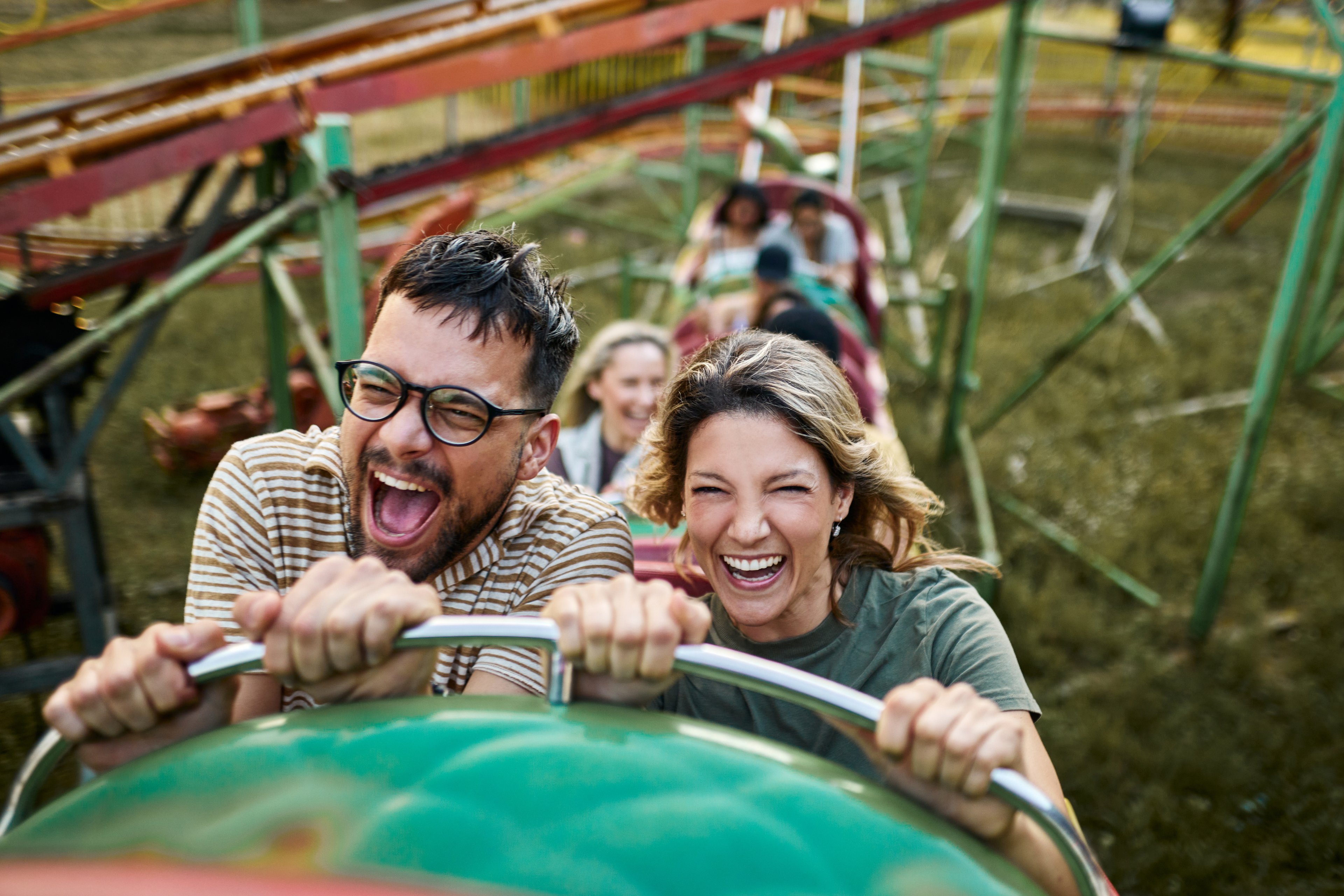Two adults on a roller coaster.