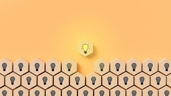 One honeycomb-shaped block shows a lit lightbulb hovering over dozens of other blocks that show dark lightbulbs.