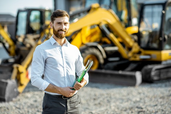 A person standing in front of industrials equipment.