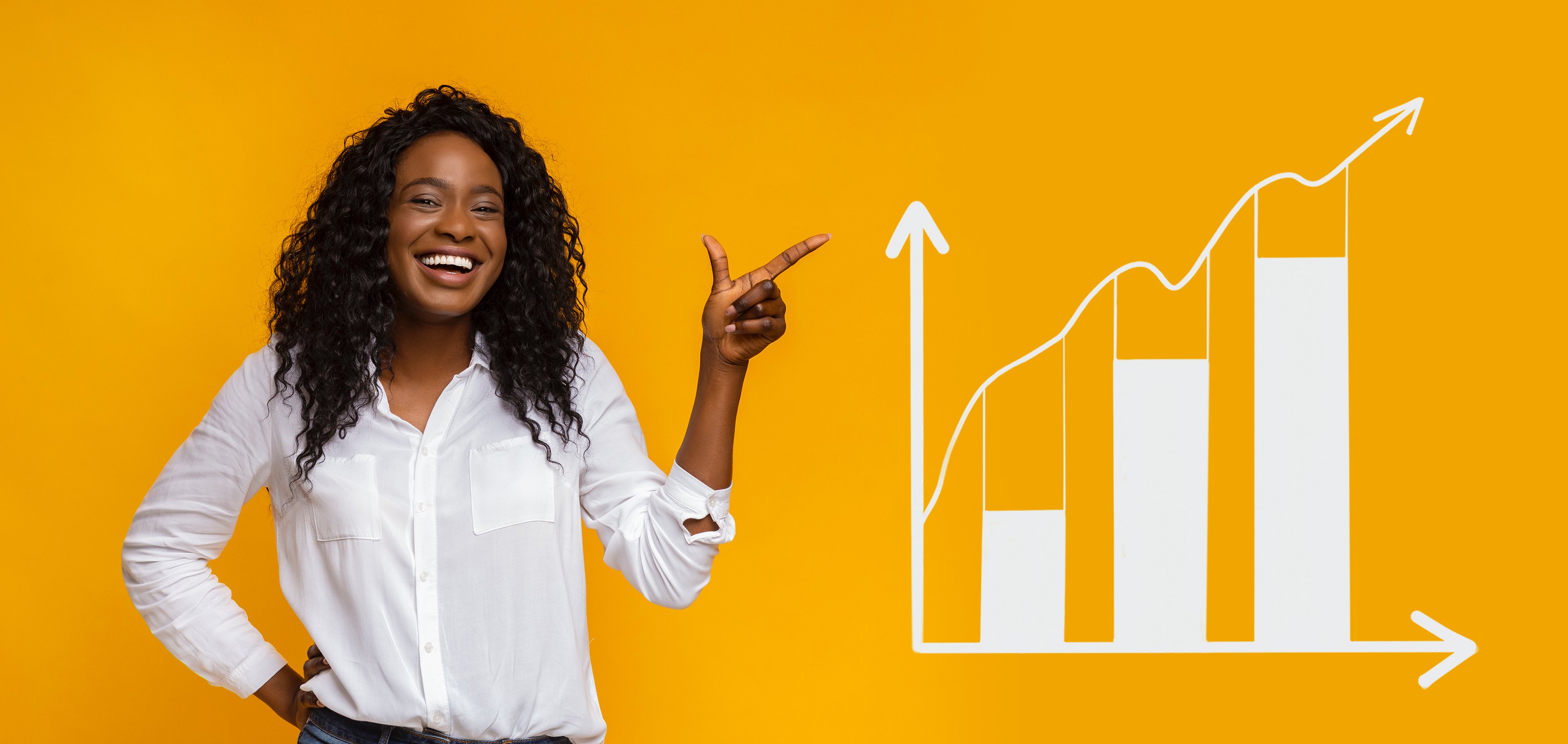 A person smiling and pointing at a chart with an upward pointing arrow.