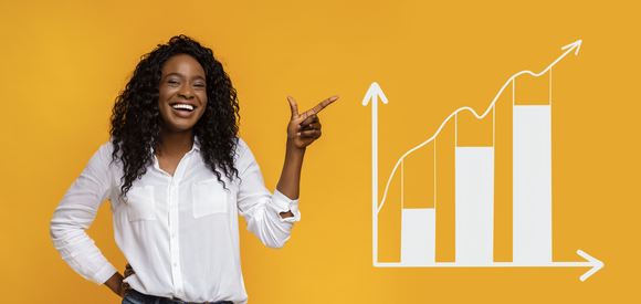 A person smiling and pointing at a chart with an upward pointing arrow.