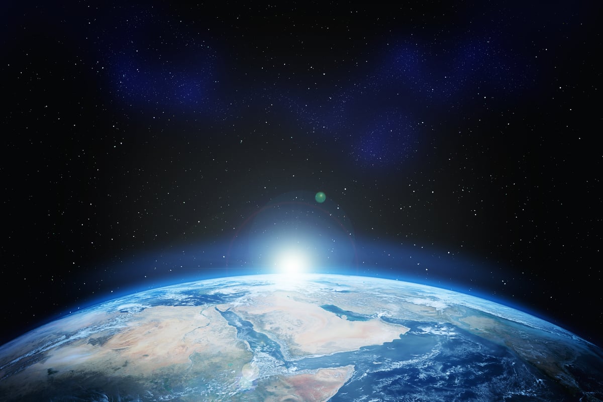 The sun rising over the Earth from space with a view of Africa and the Arabian Peninsula. 