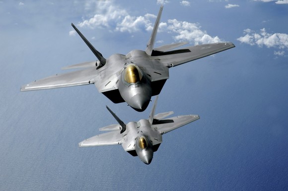 Two F-22 Raptors in flight.