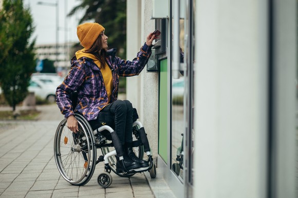 A person using an ATM.