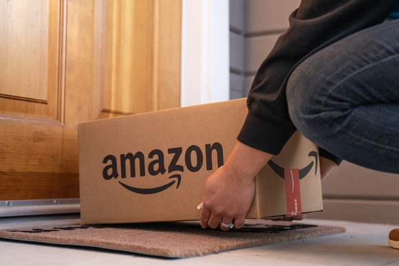 Amazon delivery box being left at front door by courier. 