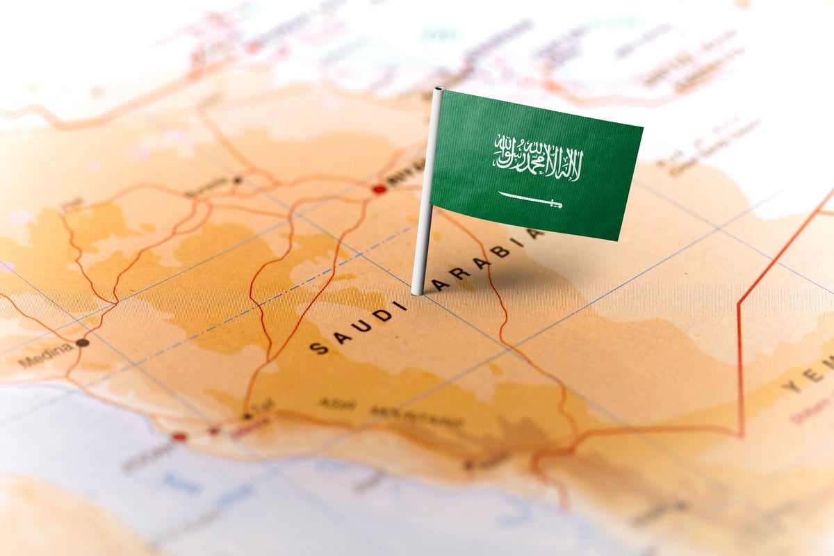 A map of Saudi Arabia with a Saudi flag pin.