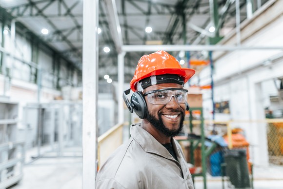 Worker wearing safety glasses and hard hat.