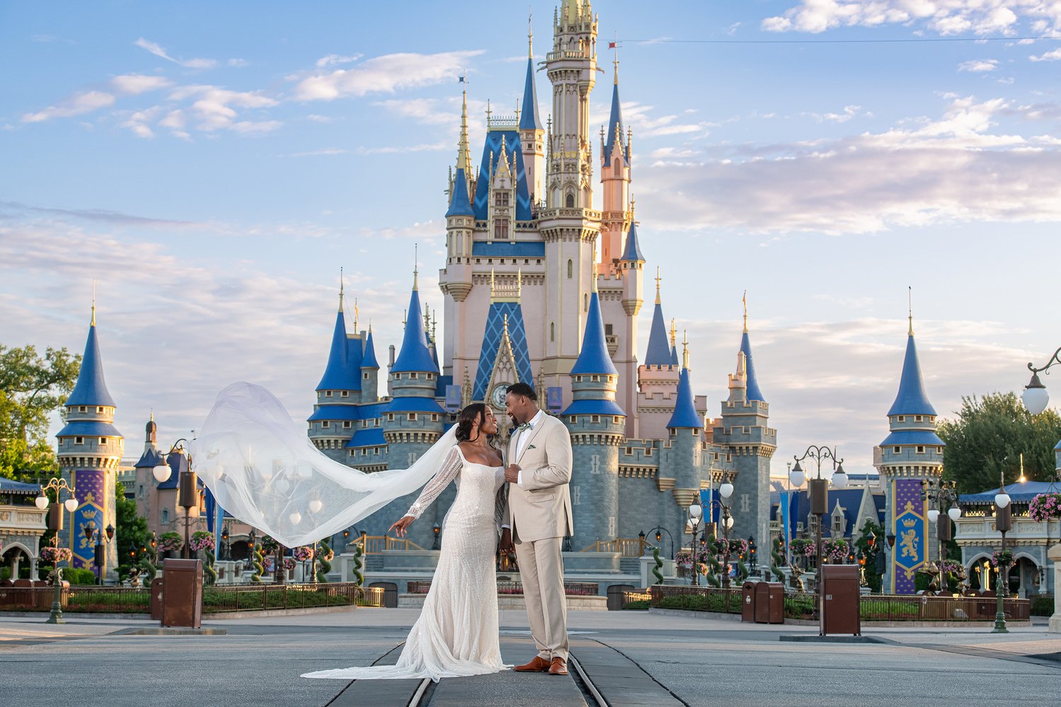 A couple taking wedding photos in front of Cinderella's castle at the Magic Kingdom.