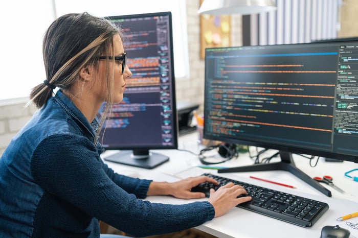 Woman analyzes data at computer. 