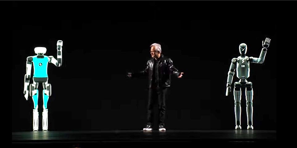 Nvidia CEO Jensen Huang on stage with images of humanoid robots on each side of him.