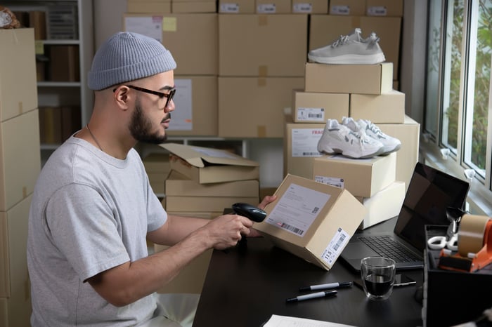 A person preparing a package for delivery.