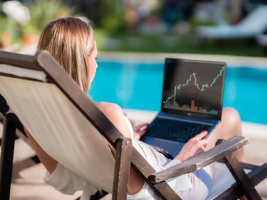 Investor with laptop at pool