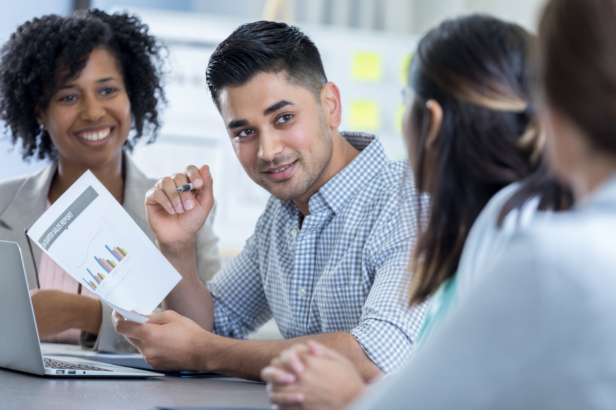 People discussing a sales report.