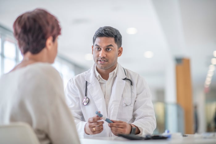 Physician talking with patient.