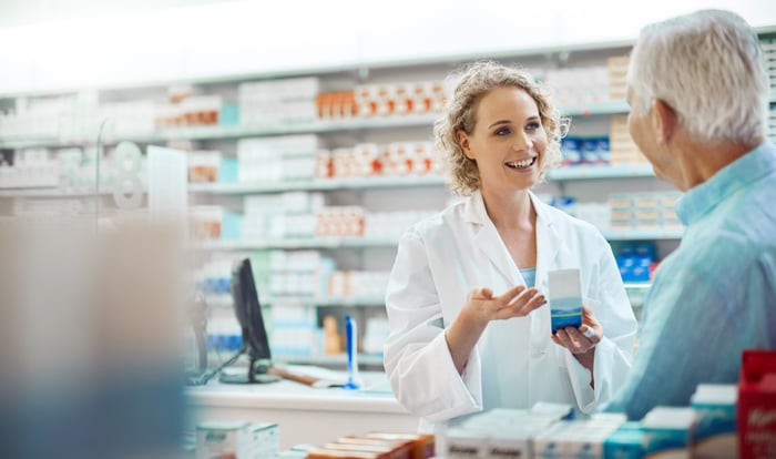 Pharmacist talking to patient.