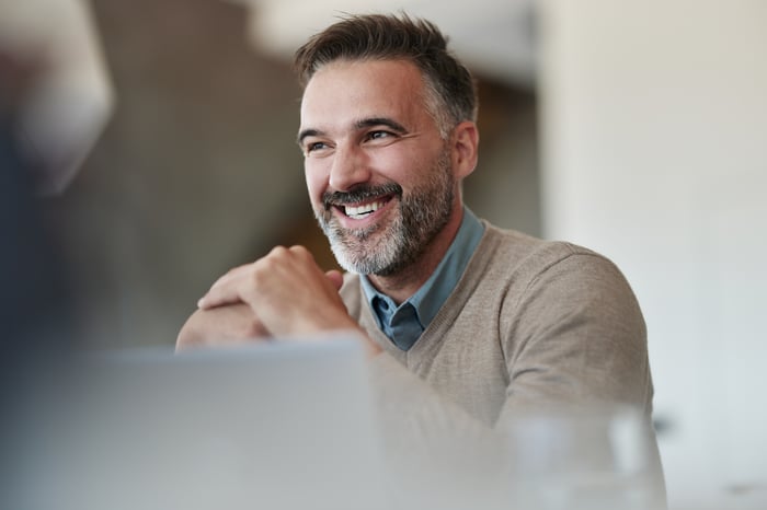 A person seated and smiling.