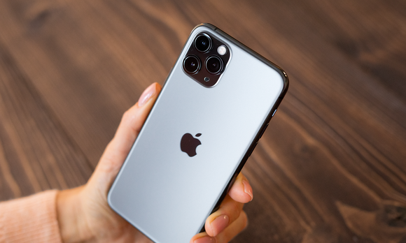 A person holds an Apple iPhone.