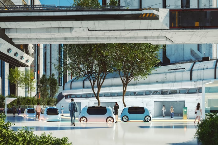 Self-driving electric vehicles lined up along a street.