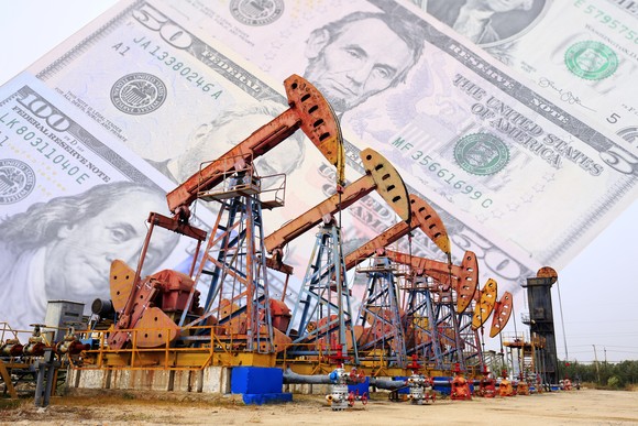 Oil pumps with money in the background. 