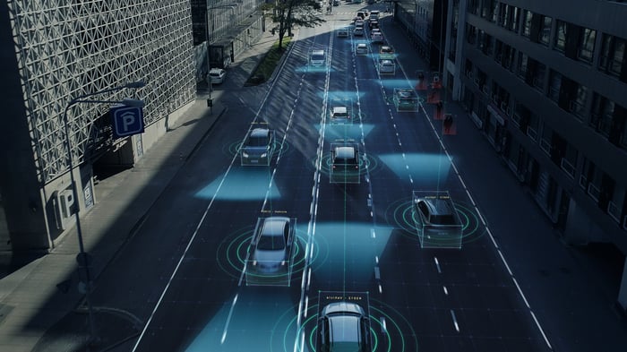 Cars use radar to drive down a city street.