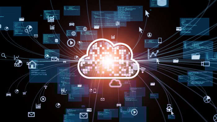 A cloud icon with lines coming from it that connect to various charts, icons, and computer screens.