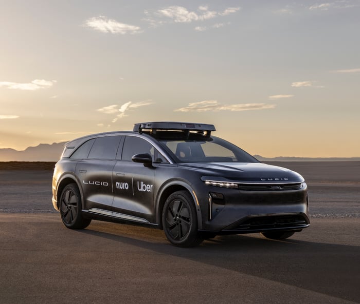 Lucid, Uber, Nuro robotaxi prototype in an outdoor setting. 