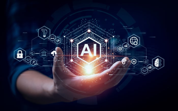 A hand holds a glowing AI symbol.