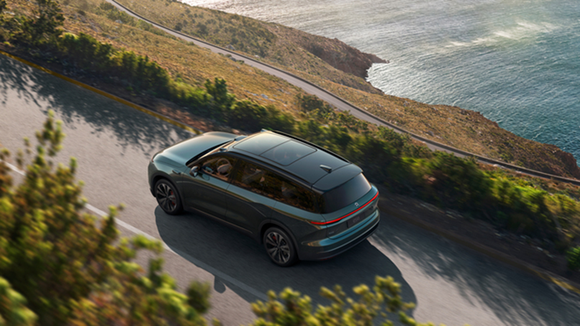 A NIO ES8 model driving along a road, seen from above.