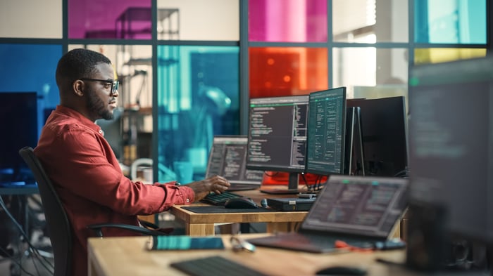 A software engineer writing code at their desk.