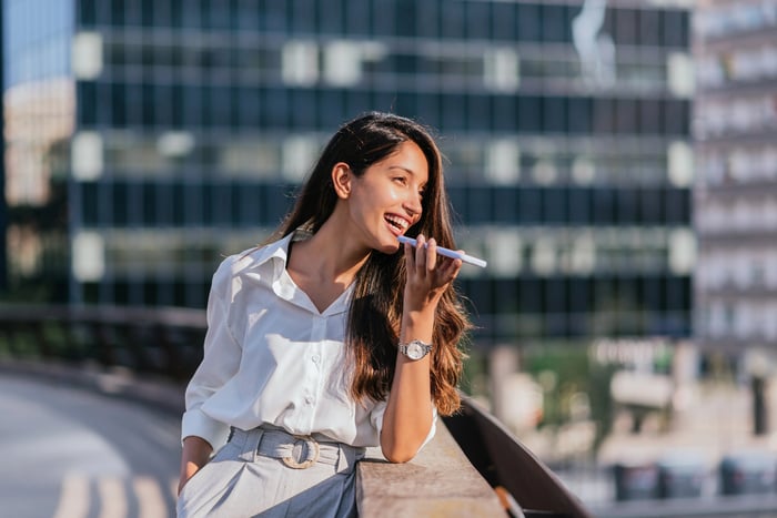 Smiling businessperson using a smartphone.