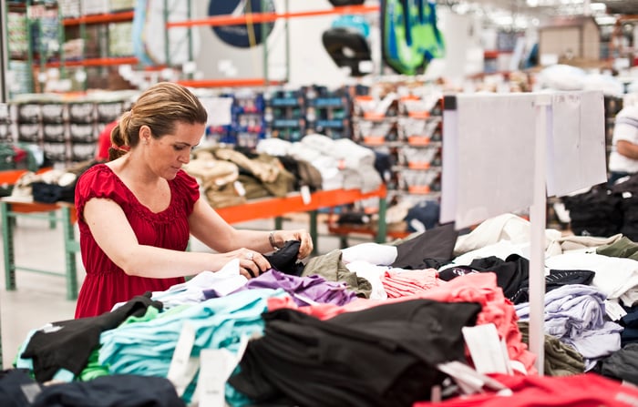 Woman shopping for clothes at warehouse store.