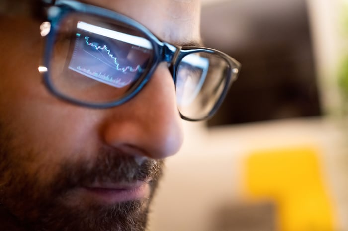 Close-up of investor staring at chart.