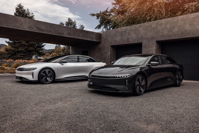 Two cars in front of a building.
