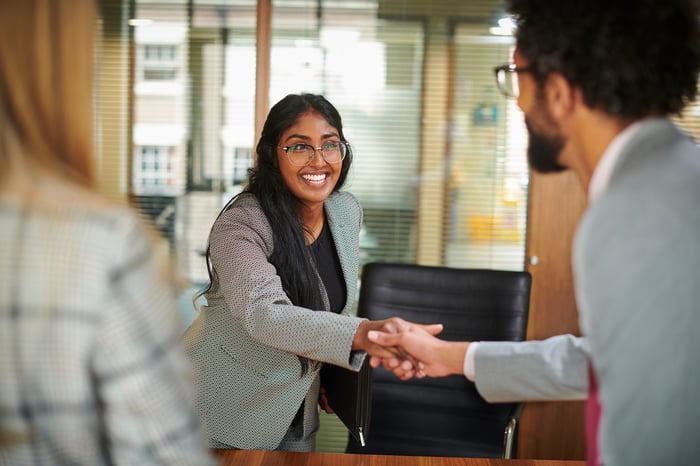 People shaking hands in an office.