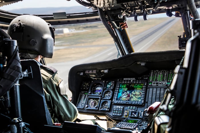 A pilot in the cockpit of a helicopter.