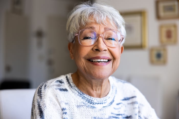 A person looking directly into the camera and smiling.