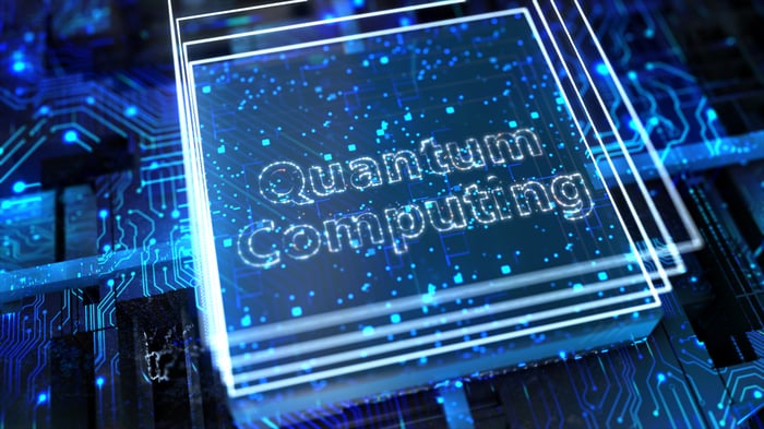 "Quantum Computing" in lighted letters with a background of lighted circuit diagrams.