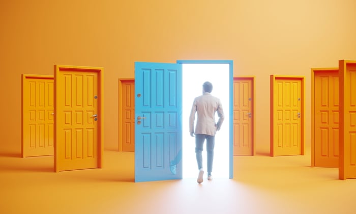 A person walking through an open door.