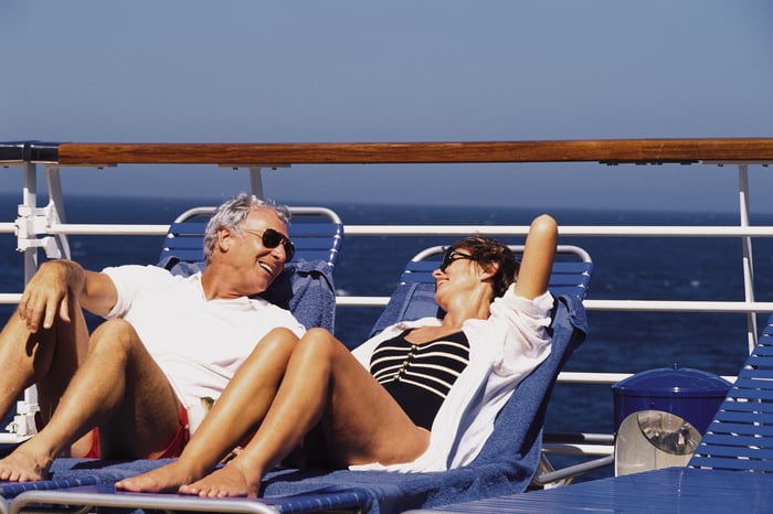 Couples lounges while on a cruise.