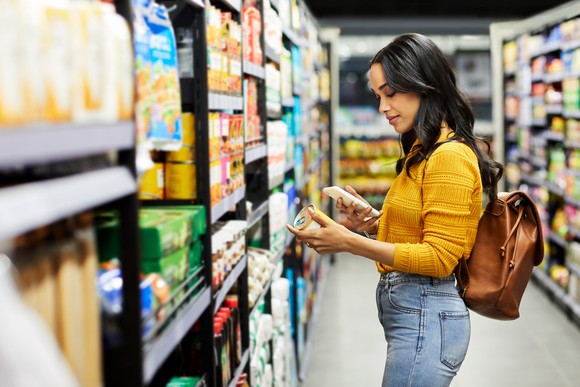 A shopper in a supermarket aisle.