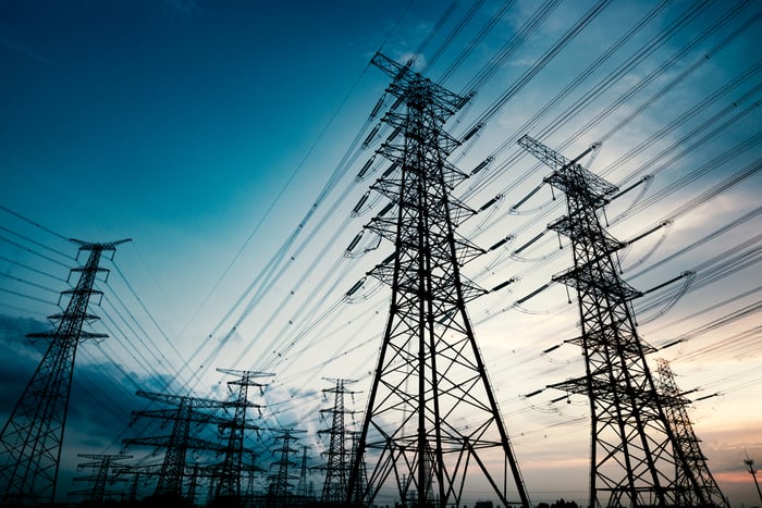 Large power transmission lines against a sky at dusk.