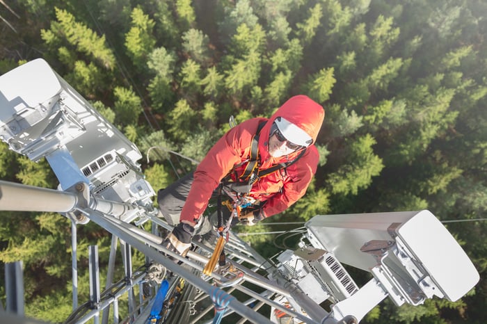 A worker climbing a cell tower.