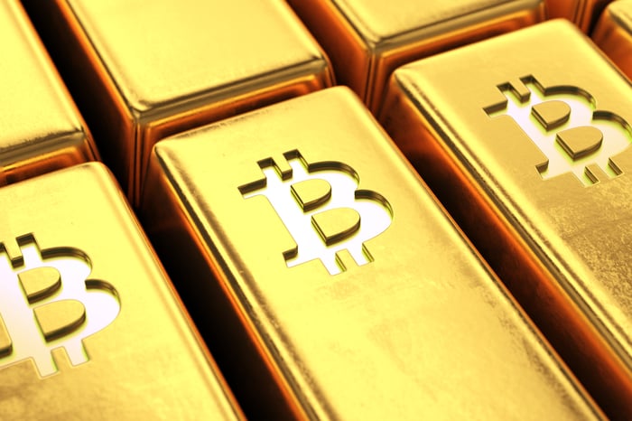 Gold bars with the Bitcoin symbol on them. 