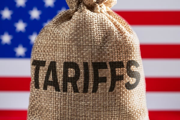 A bag with the word tariffs on it in front of the American flag.
